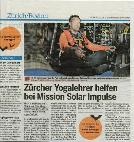 Newspaper article with a photo of pilot André Borschberg meditating in a cockpit.